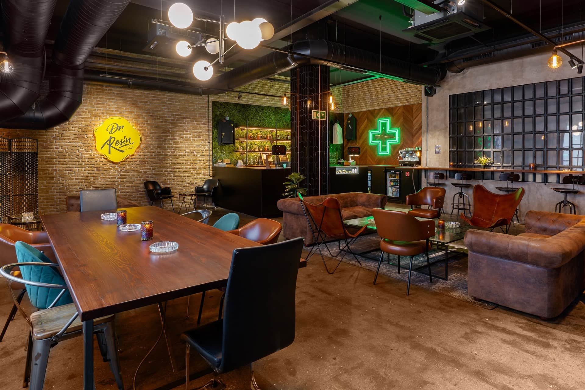 In the stylish lounge with brick walls and a bar area, social cannabis club Dr. Resin Barcelona