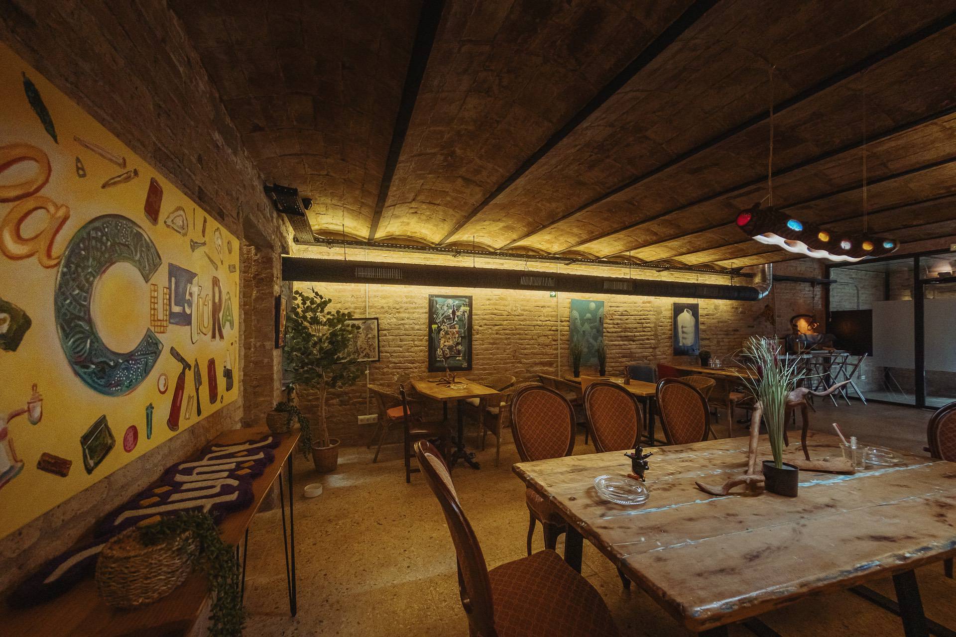 Creative interior of the cannabis association Cultura Barcelona with mural and lounge seating