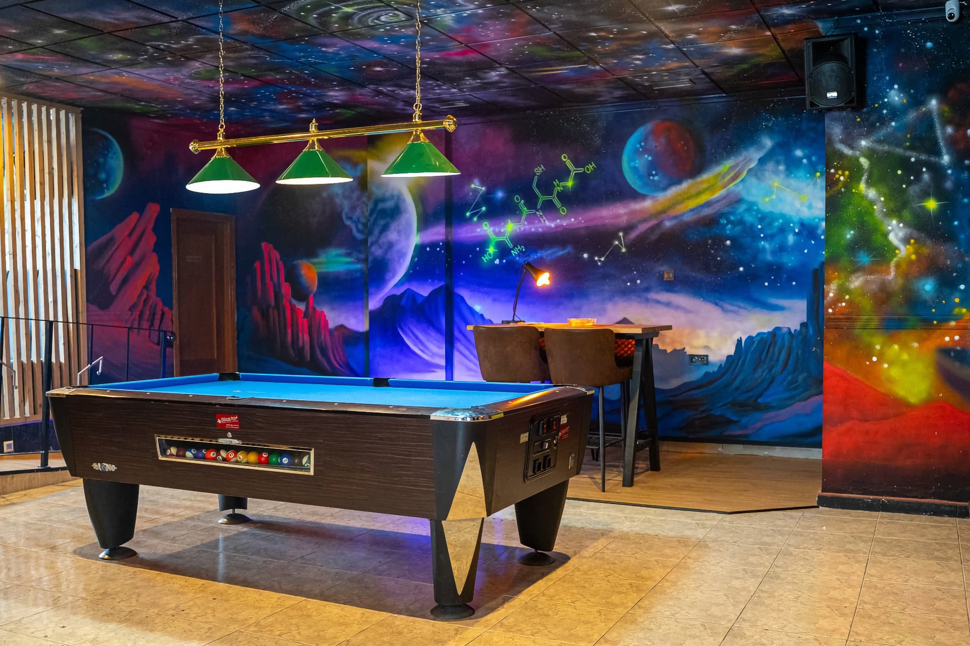 Space-themed mural and pool table in the Sky cannabis club Alicante