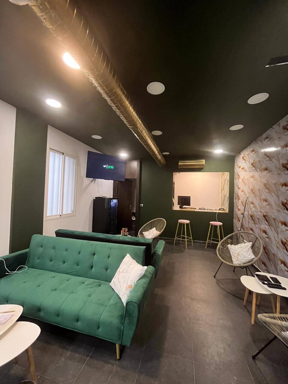 Main room of the cannabis association Green Paradise in Madrid with green sofas