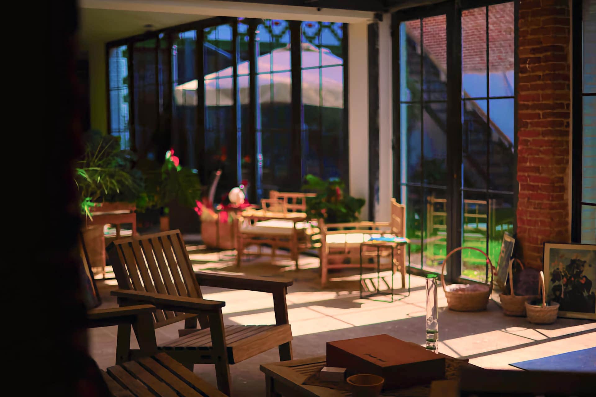 Modern lounge with brick walls and rattan sofas in the Noviciado cannabis club, Madrid