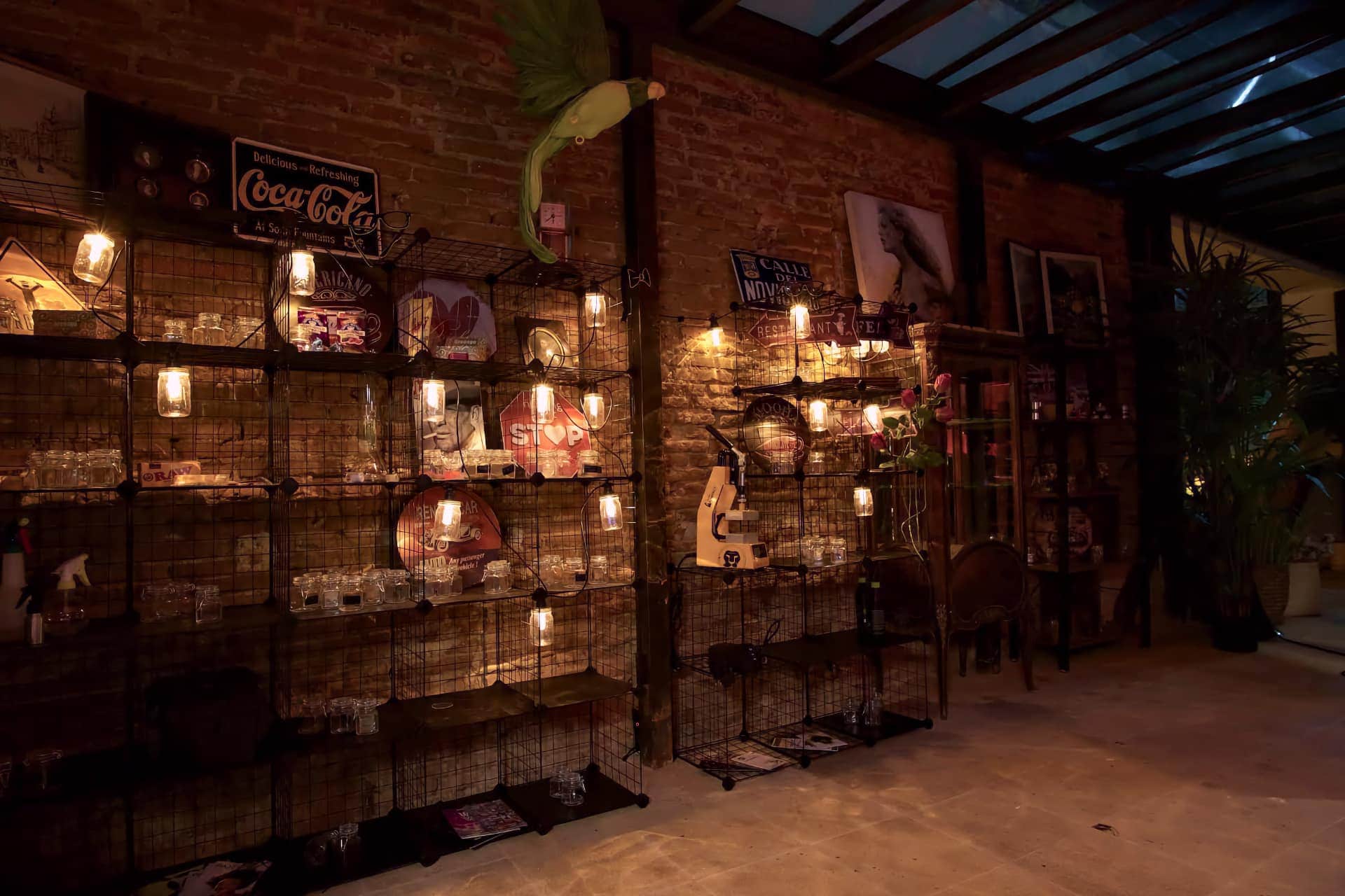 Shelves with retro décor and warm lights in the Madrid Noviciado social cannabis club